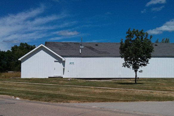 Some sort of storage shed, plus a tree