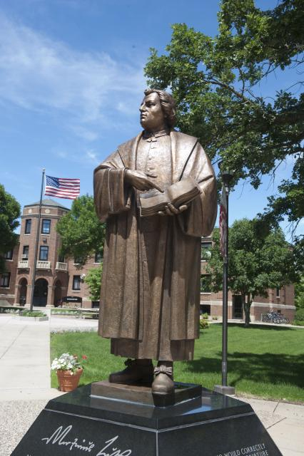 Martin Luther College (statue of Luther pointing to a passage in the Bible and asking "Who wrote this shit?"
